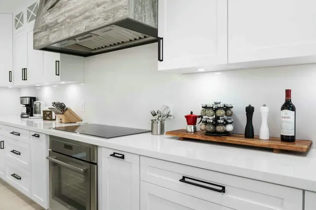 a kitchen with stainless steel appliances white cabinets and a sink