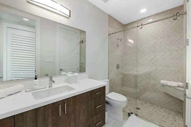 a bathroom with a sink shower and a toilet