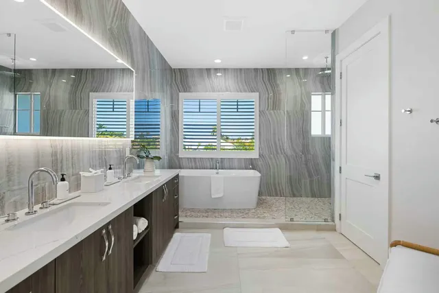 a bathroom with a granite countertop sink and a bathtub
