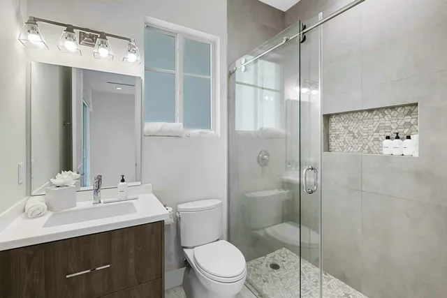 a bathroom with a sink toilet and shower