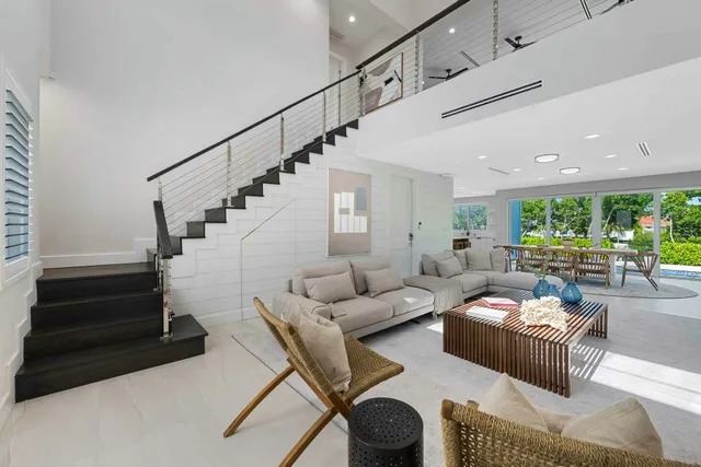 a living room with furniture and stairs