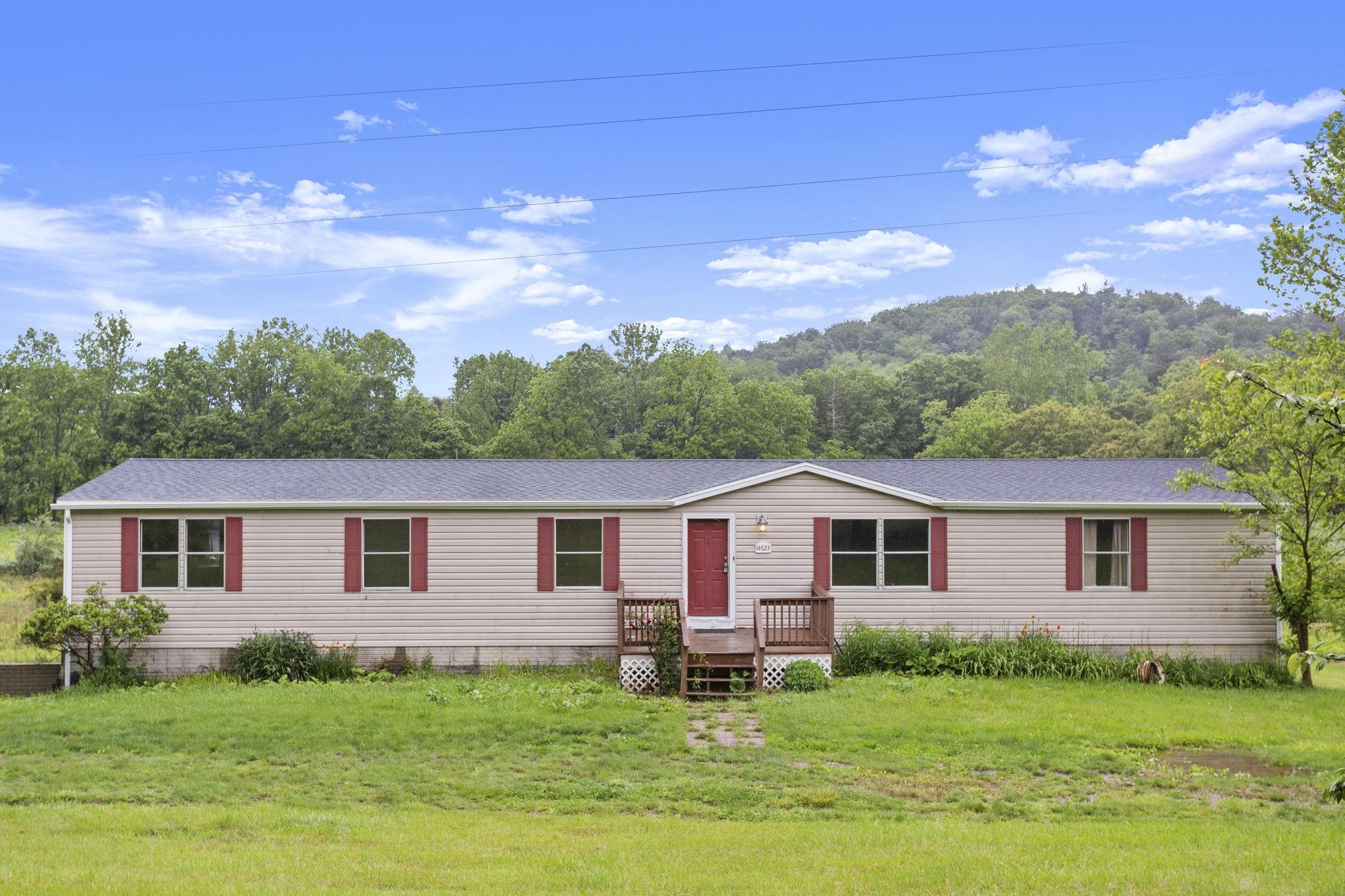a front view of a house with a garden