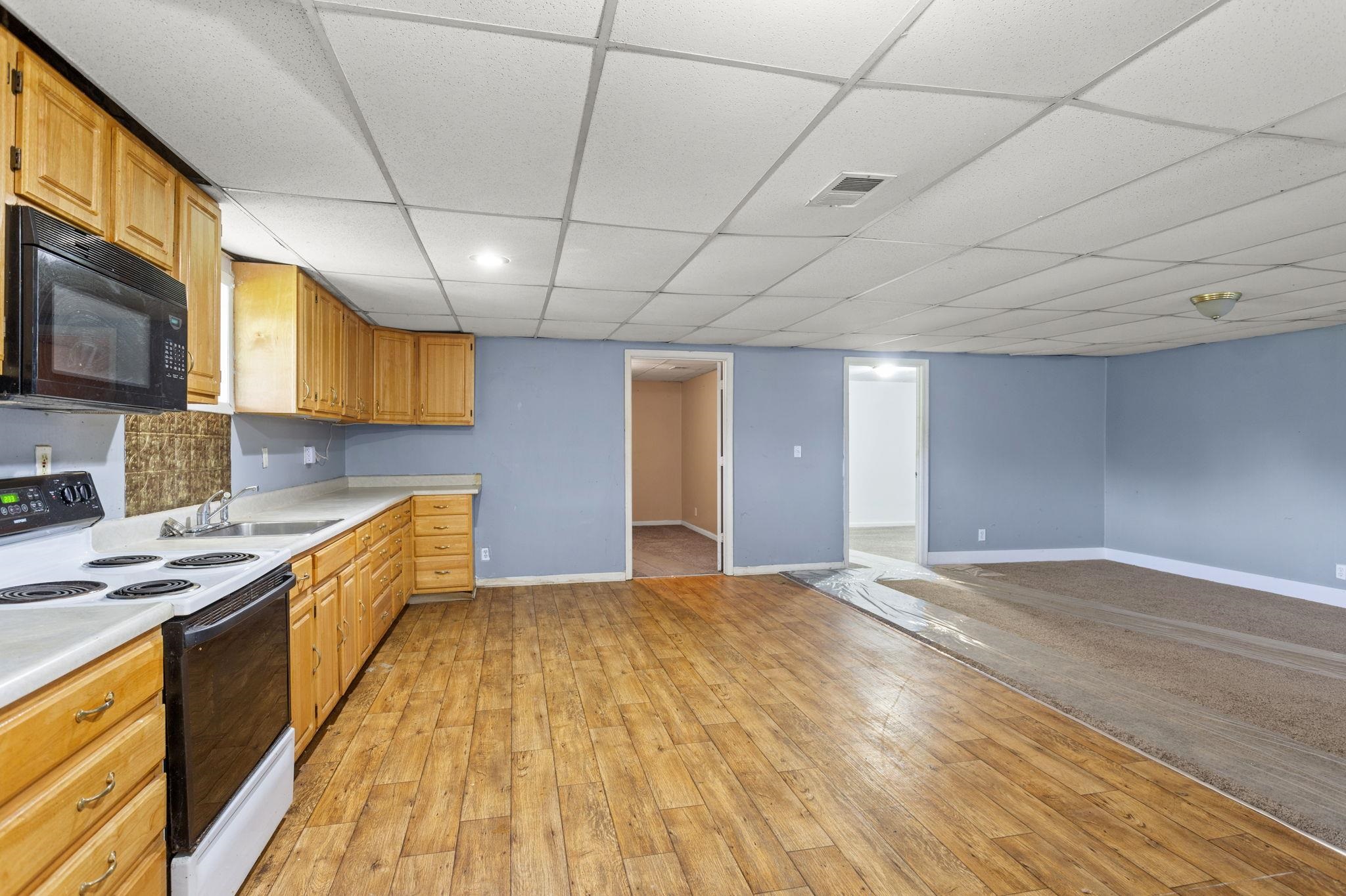 14623 Runions Creek Road Broadway, VA 22815 - Photo 17 of 30 a large kitchen with stainless steel appliances granite countertop a sink a stove counter space and cabinets
