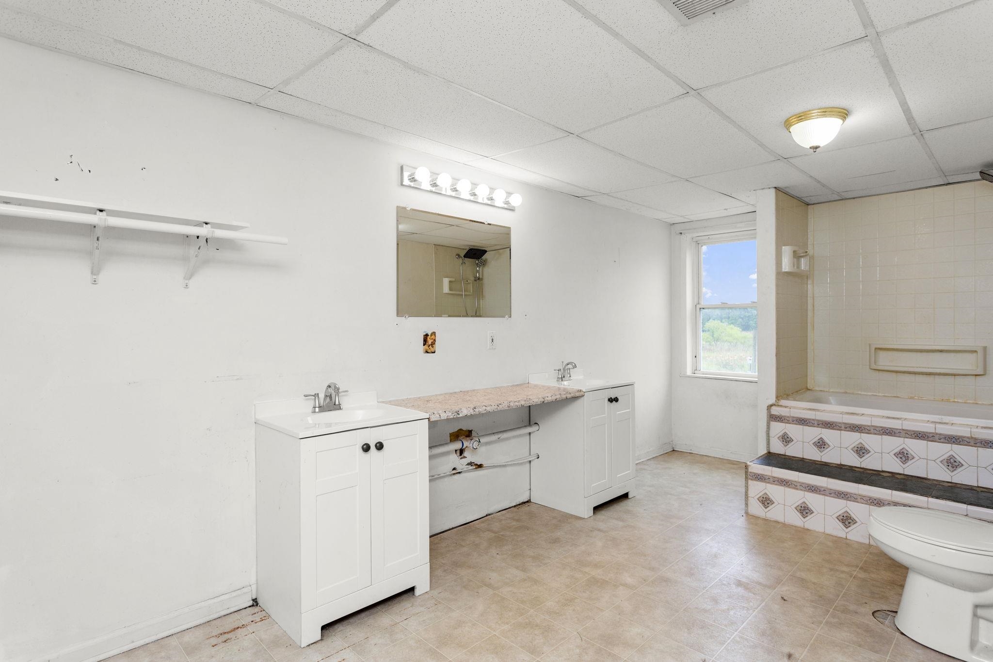 14623 Runions Creek Road Broadway, VA 22815 - Photo 23 of 30 a view of a kitchen with a sink and dishwasher with white cabinets