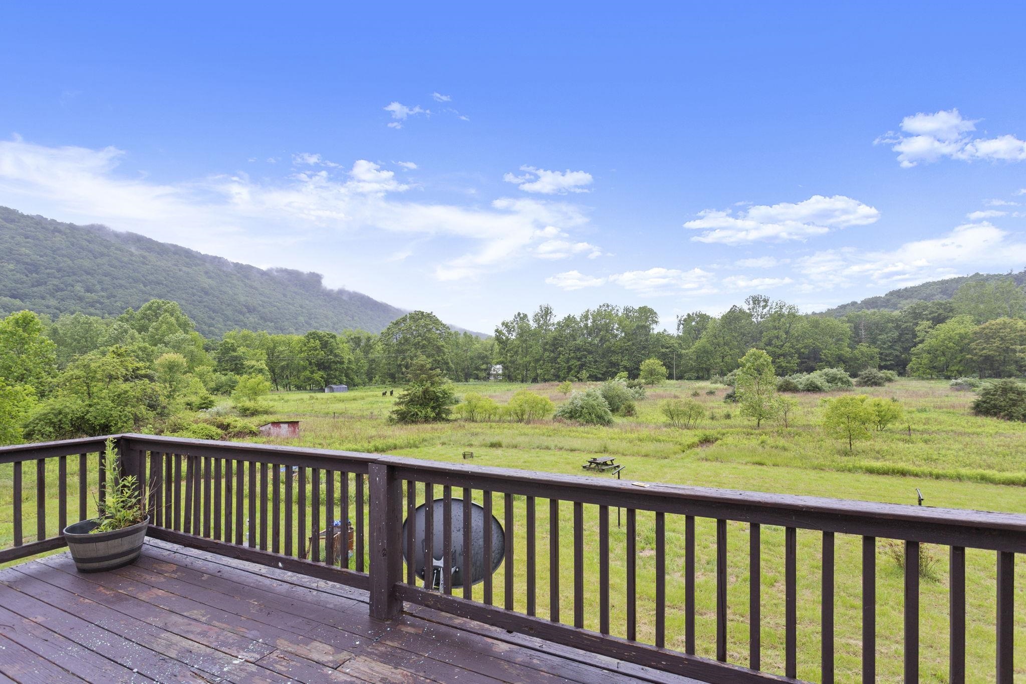 14623 Runions Creek Road Broadway, VA 22815 - Photo 25 of 30 a balcony with wooden floor and outdoor space