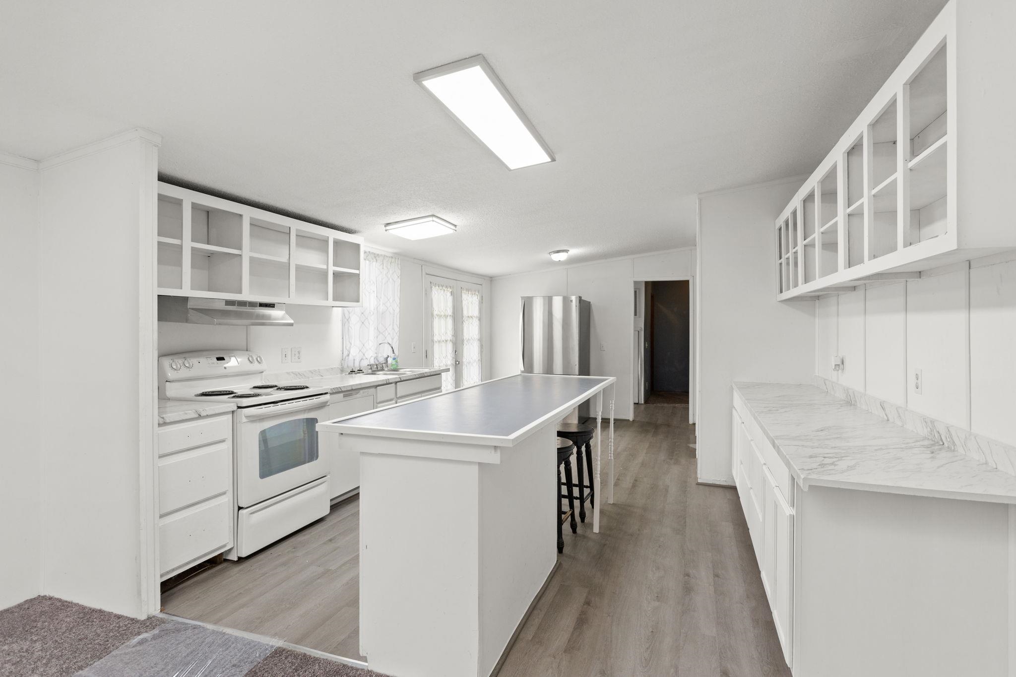 14623 Runions Creek Road Broadway, VA 22815 - Photo 6 of 30 a kitchen with stainless steel appliances granite countertop a sink stove and refrigerator