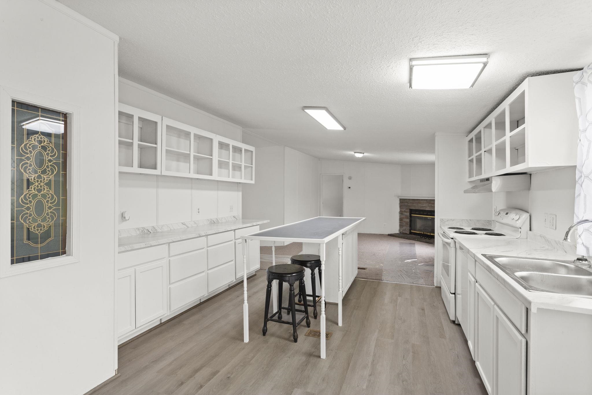 14623 Runions Creek Road Broadway, VA 22815 - Photo 8 of 30 a kitchen with stainless steel appliances granite countertop a kitchen island hardwood floor sink stove and white cabinets