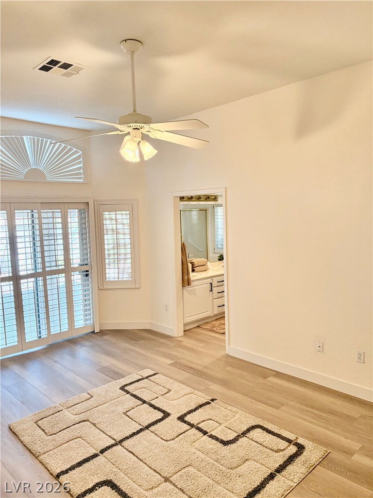 9040 Dove River Road Las Vegas, NV 89134 - Photo 11 of 22 Gleaming wood-look floors anchor this airy bedroom complete with plantation shutters and an adjoining bath.