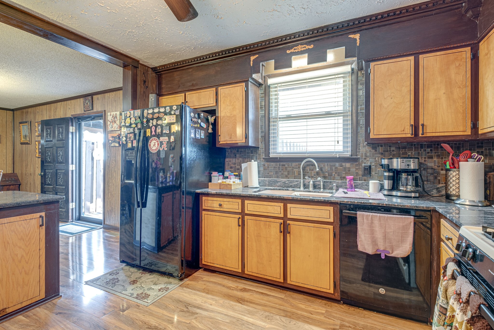 4840 Concord Drive Hermitage, TN 37076 - Photo 5 of 34 a kitchen with stainless steel appliances granite countertop a refrigerator a sink dishwasher a stove and a dining table with wooden floor