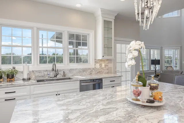 a kitchen with kitchen island a sink stove and refrigerator