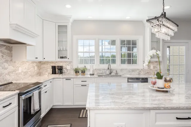 a spacious bathroom with a granite countertop sink double vanity and a mirror