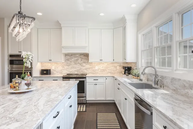 a living room with furniture fireplace and a large window