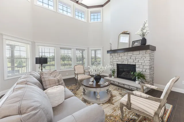a living room with furniture and a dining table with wooden floor