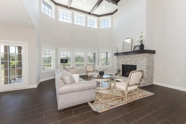 a room with furniture a air conditioner vent and white walls