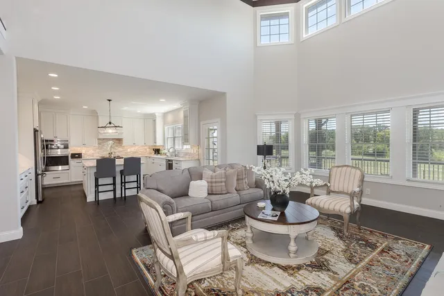 a spacious bathroom with double vanity sink a bathtub a mirror a vanity a lamp and window