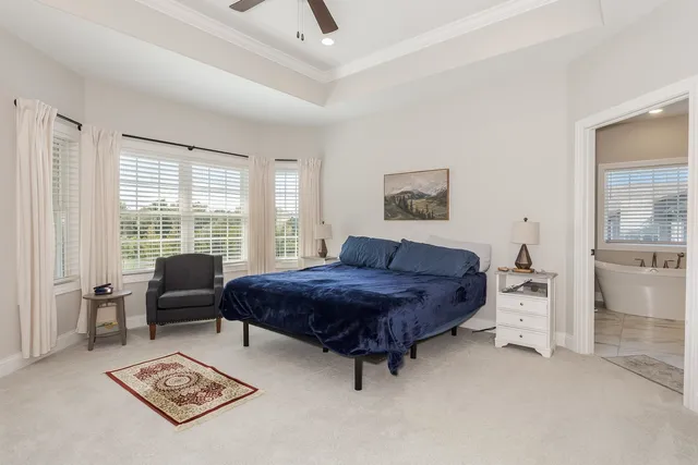 a spacious bedroom with a bed and a chandelier