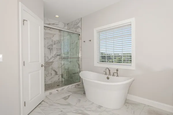 a bathroom with a sink a toilet a tub and shower