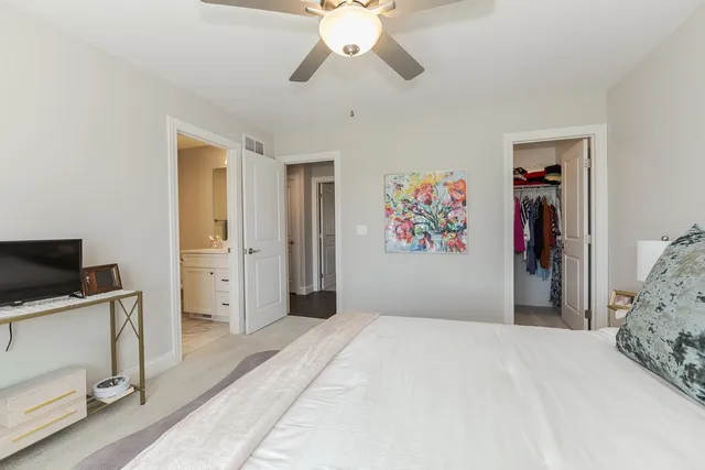 a bedroom with bed and a chandelier