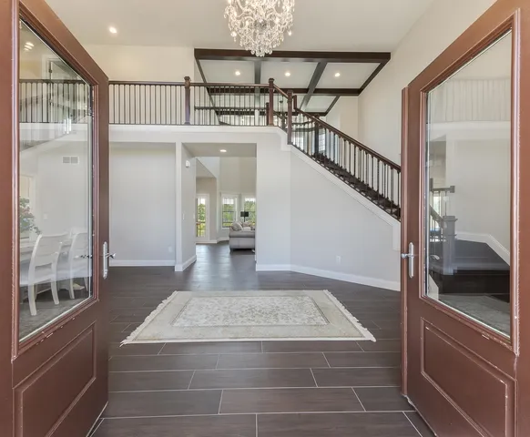 a view of entryway and hall with wooden floor
