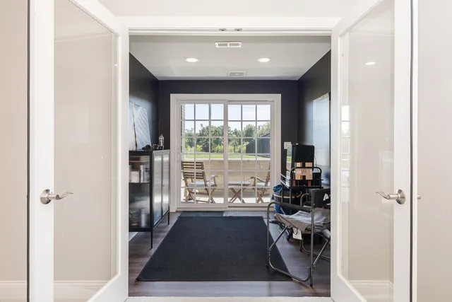 a view of a house with a small deck