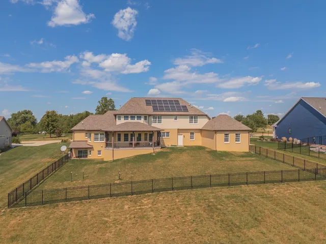 an aerial view of a house with a lake view