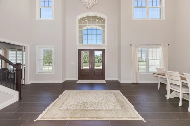 an entryway with wooden floor and windows