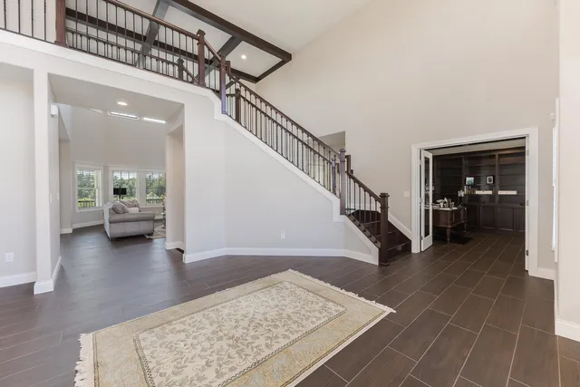 a view of entryway and hall with wooden floor