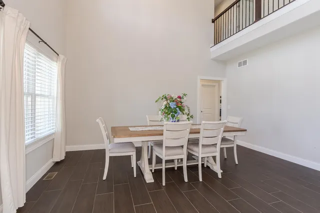 a kitchen with kitchen island granite countertop wooden floors and white cabinets