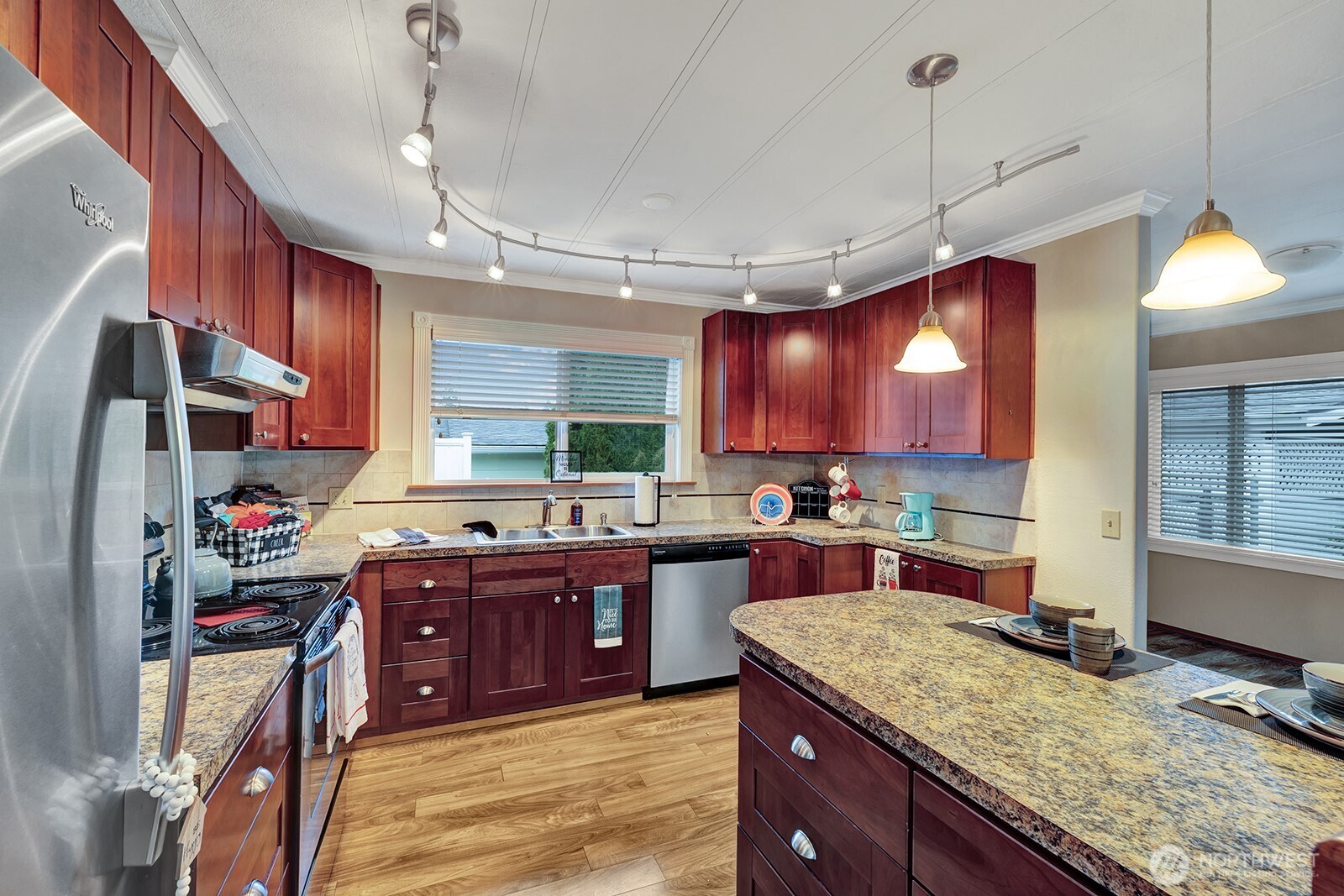 2500 Alder Street, Unit 16 Milton, WA 98354 - Photo 6 of 20 a kitchen with kitchen island granite countertop a sink cabinets and window