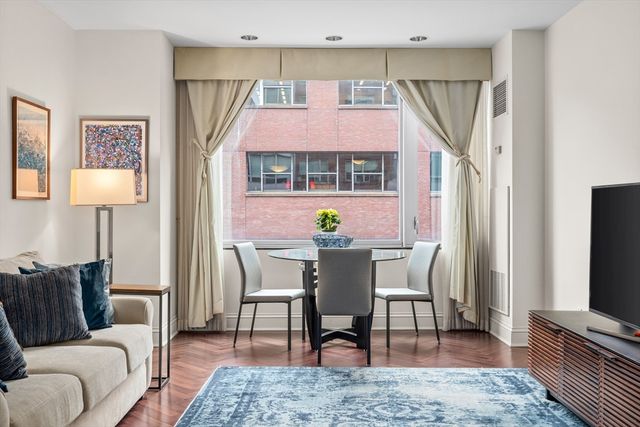 a living room with furniture a rug and a flat screen tv