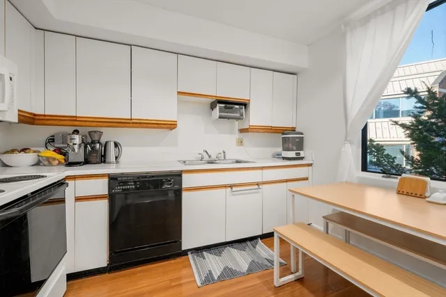 a kitchen with a sink cabinets and window