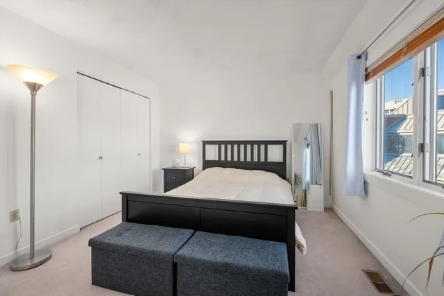 a bedroom with a bed and window