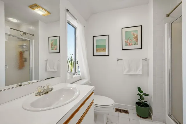 a bathroom with a sink toilet and a mirror