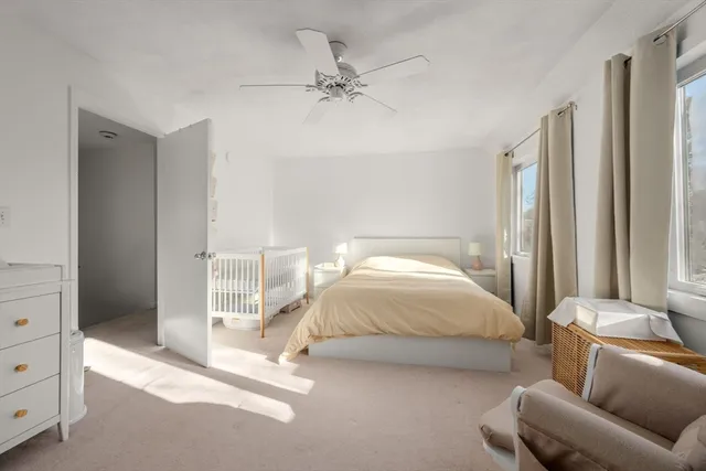 a spacious bedroom with a bed and a couch