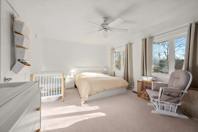 a spacious bedroom with a bed and a window