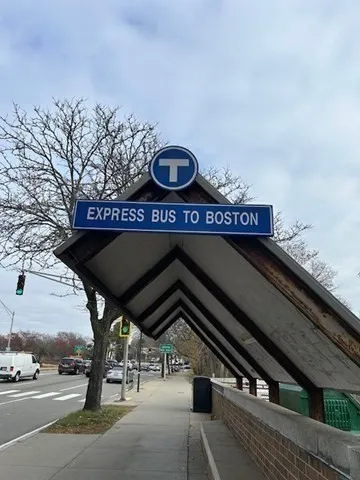 a front view of a building with trees