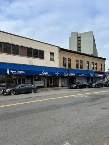 a view of a roof deck with couches and wooden floor