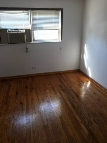 a view of a room with wooden floor and windows