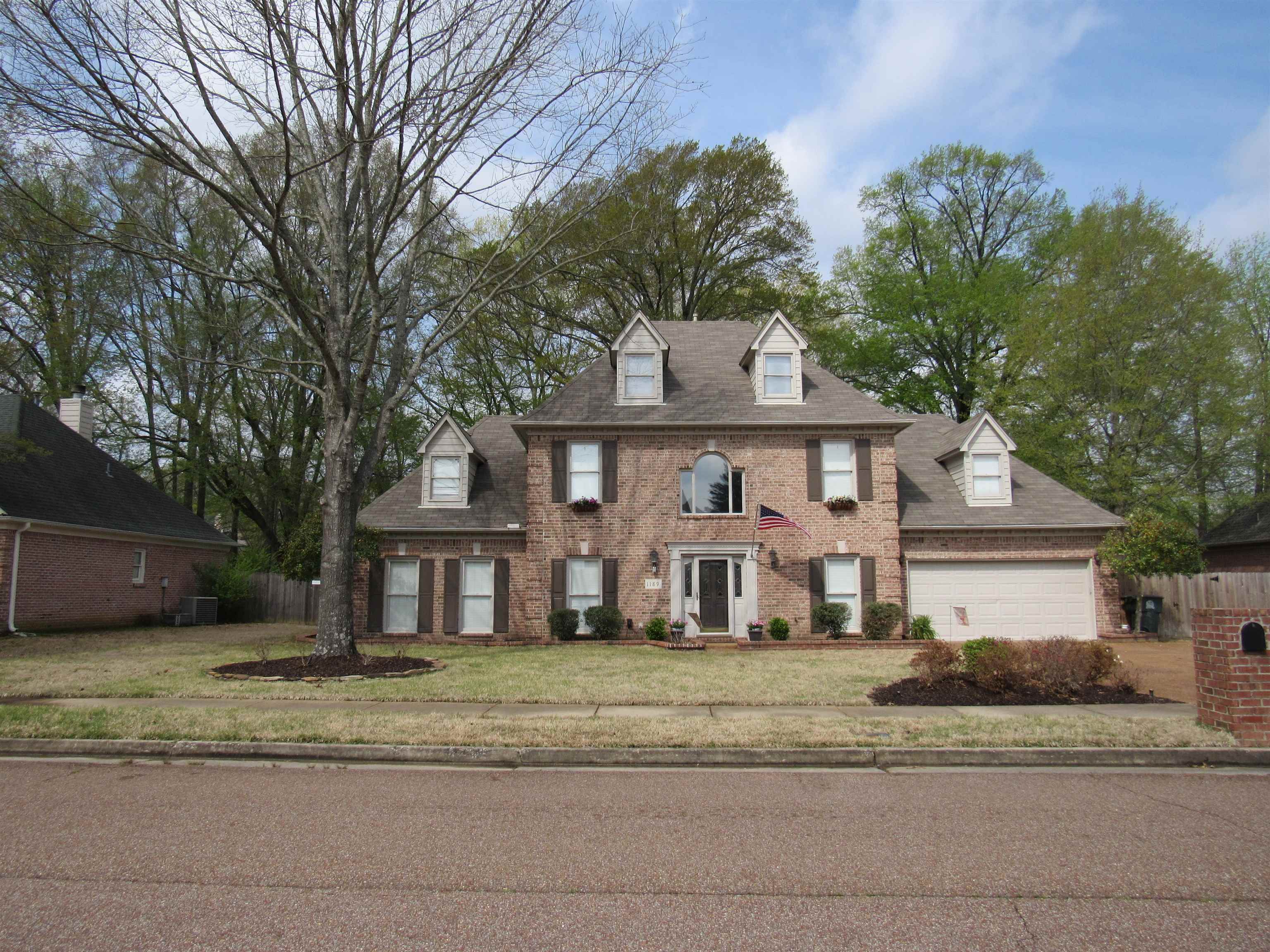 1189 Macon Ridge Drive Collierville, TN 38017 - Photo 1 of 22 a front view of a house with a yard