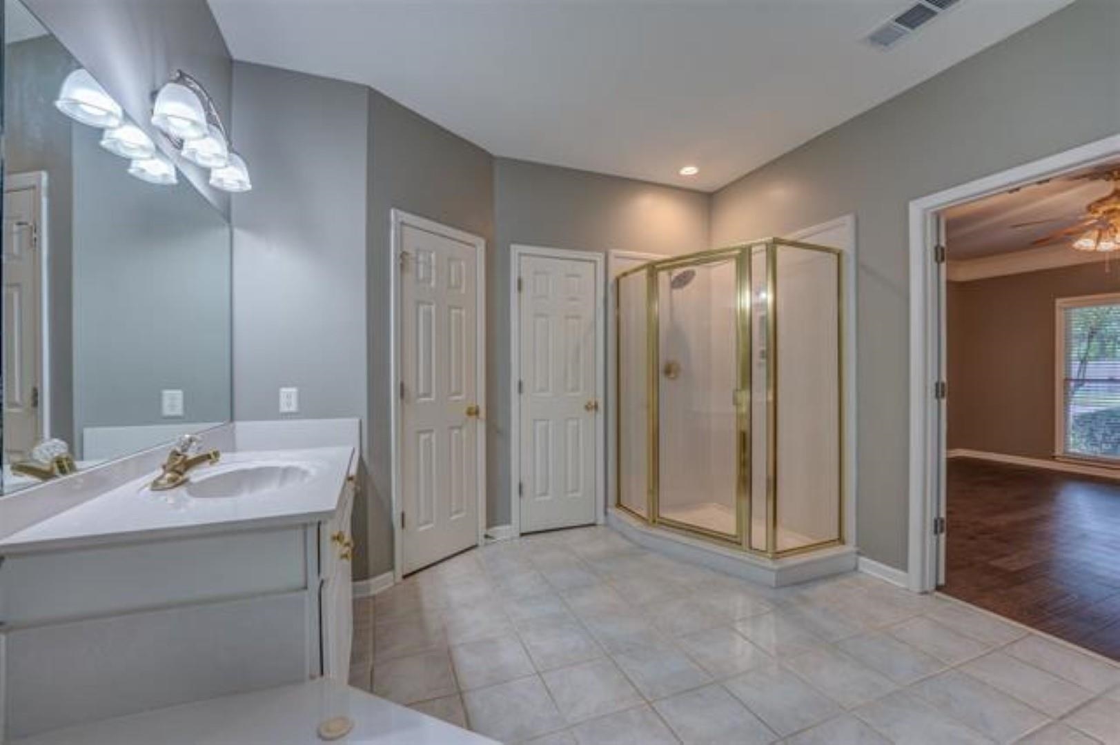 1189 Macon Ridge Drive Collierville, TN 38017 - Photo 12 of 22 a bathroom with a double vanity sink mirror and shower