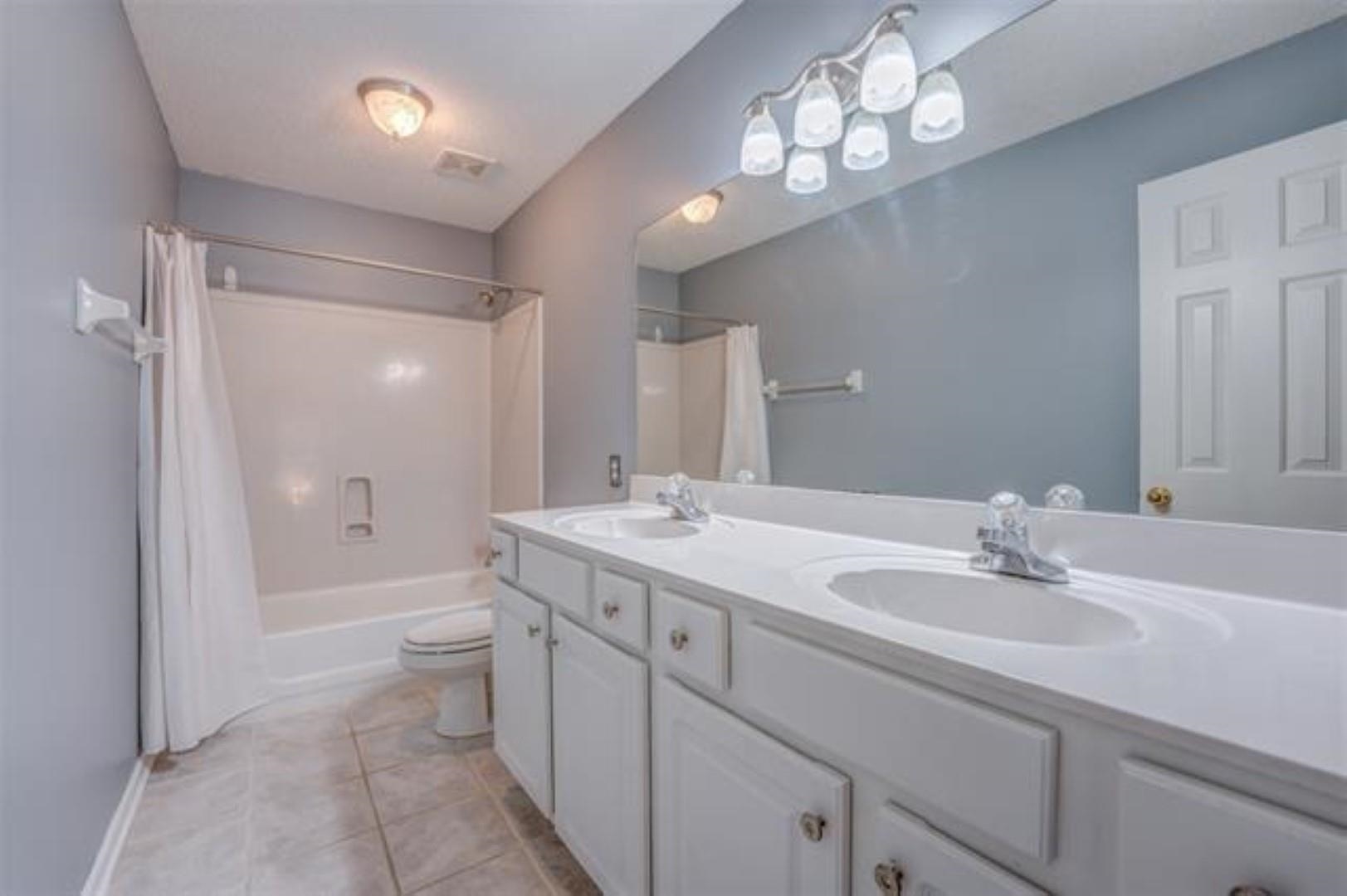 1189 Macon Ridge Drive Collierville, TN 38017 - Photo 14 of 22 a bathroom with a sink a toilet and shower