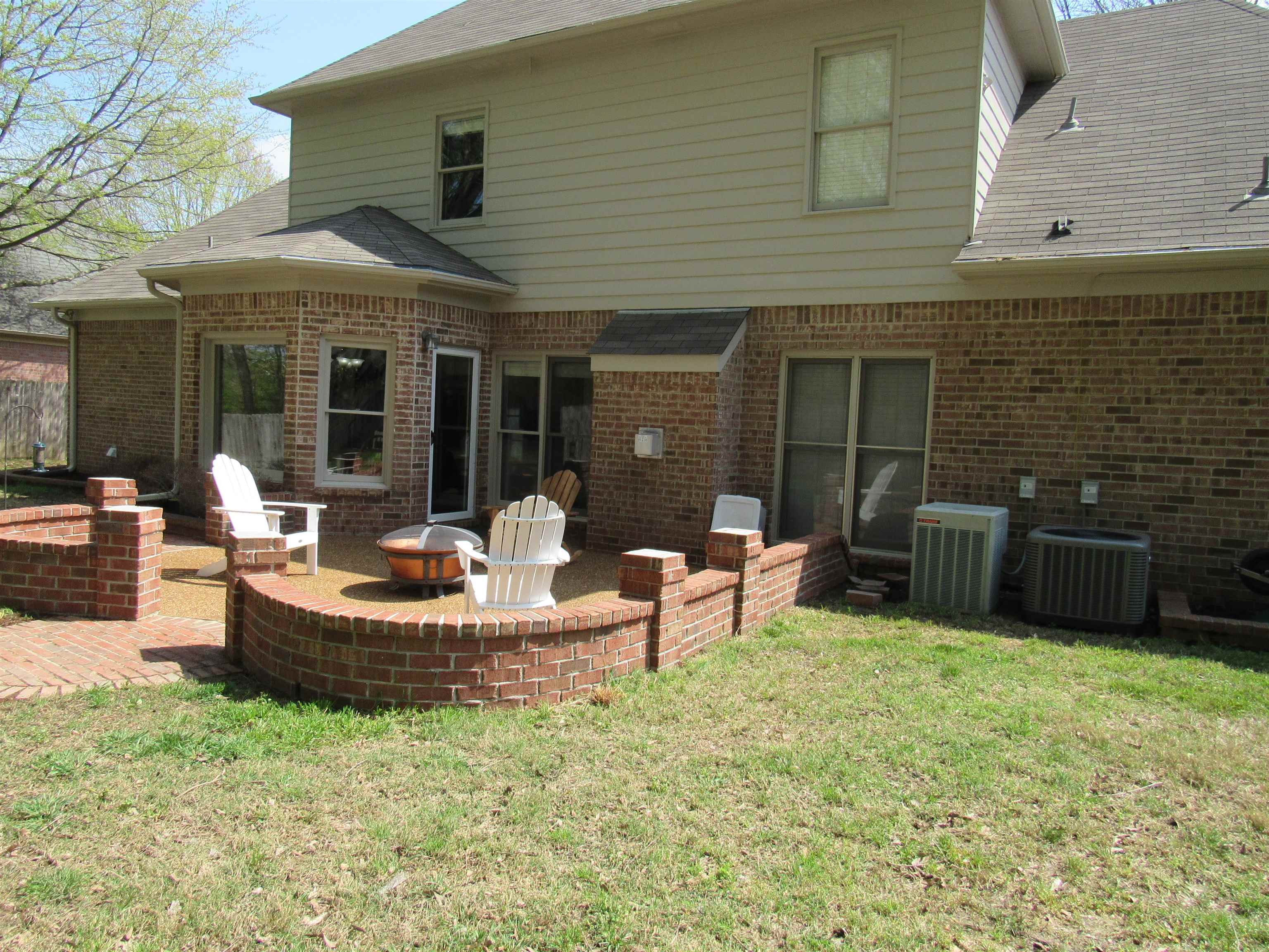 1189 Macon Ridge Drive Collierville, TN 38017 - Photo 21 of 22 a view of a patio with table and chairs potted plants with wooden fence
