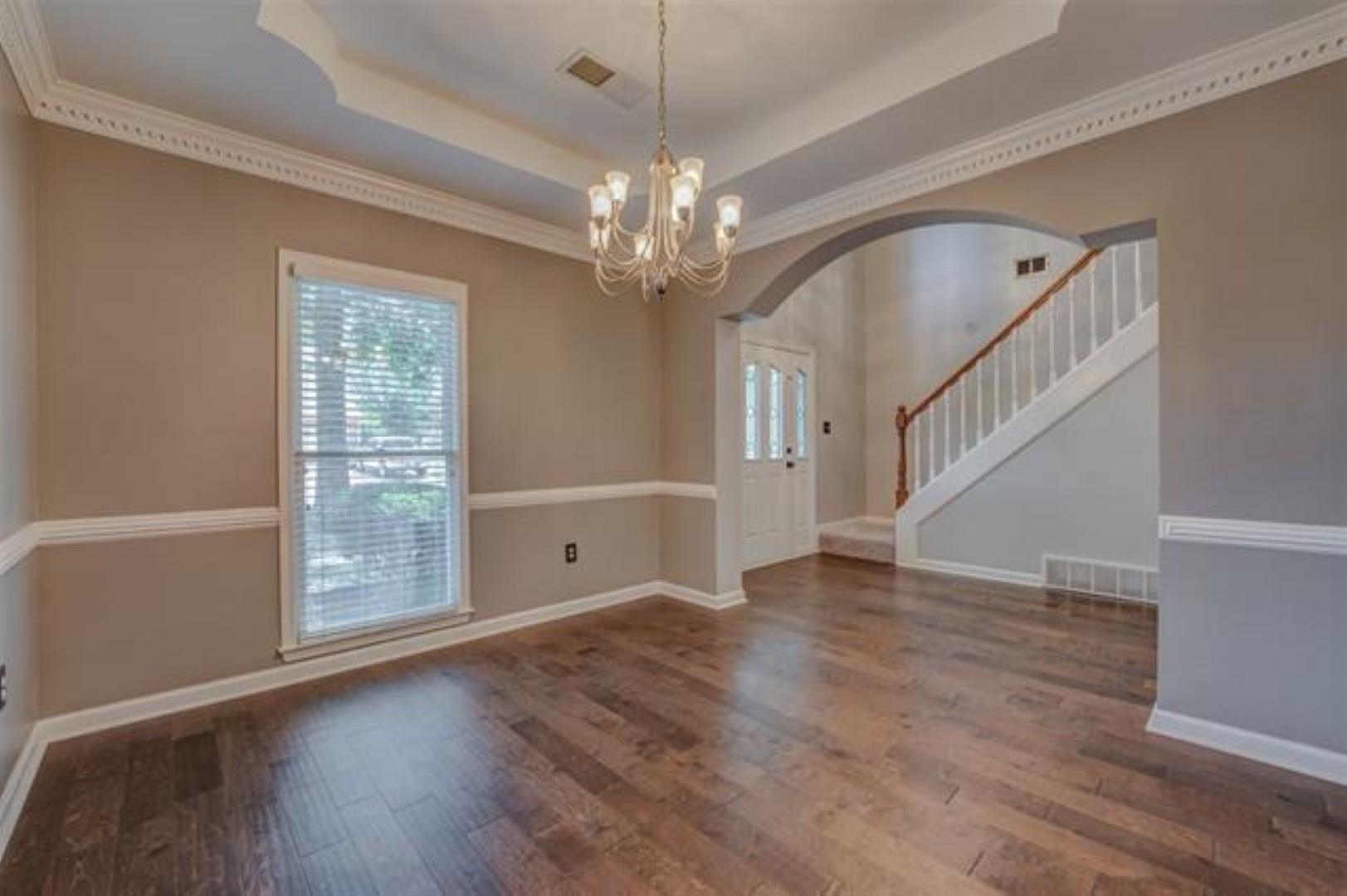 1189 Macon Ridge Drive Collierville, TN 38017 - Photo 3 of 22 a view of an empty room with wooden floor and a window