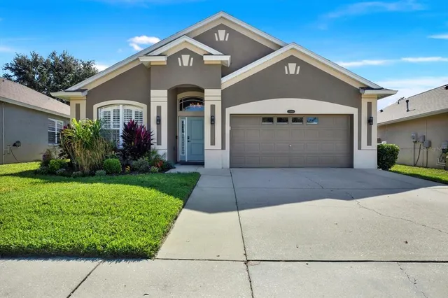 a front view of a house with a yard and garage