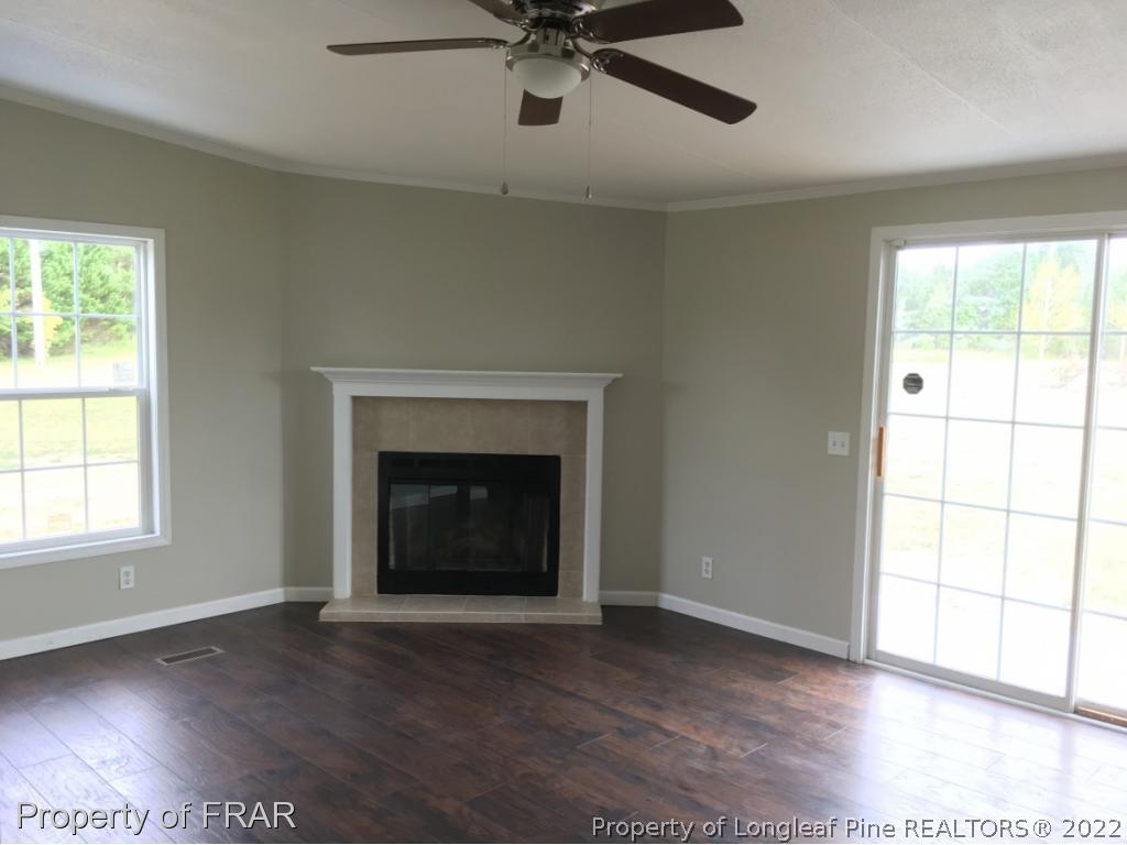 7692 Smithfield Road Godwin, NC 28344 - Photo 14 of 36 an empty room with windows and fireplace