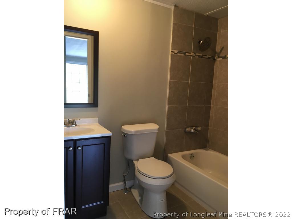 7692 Smithfield Road Godwin, NC 28344 - Photo 18 of 36 a bathroom with a toilet and a shower