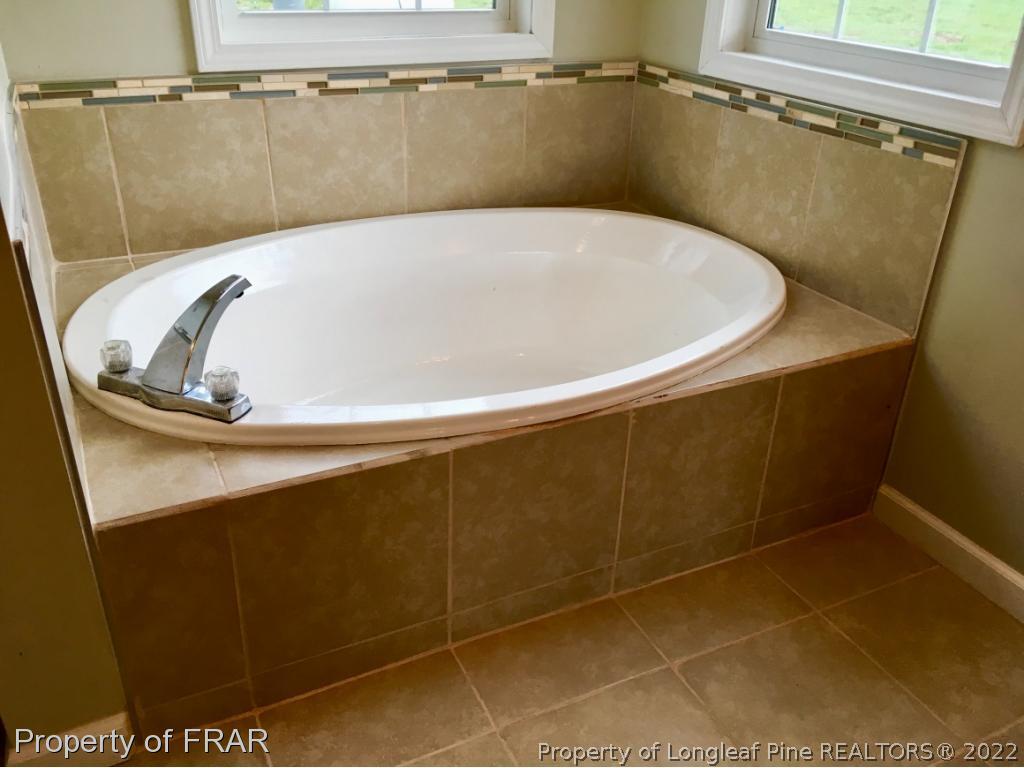 7692 Smithfield Road Godwin, NC 28344 - Photo 26 of 36 a view of a bathroom with a bathtub