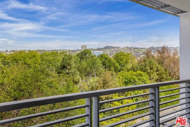 a bedroom with a large bed and wooden floor
