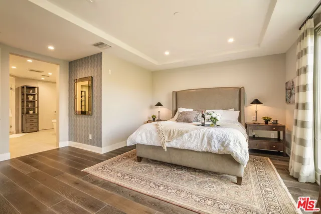 a bedroom with a large bed and a large window