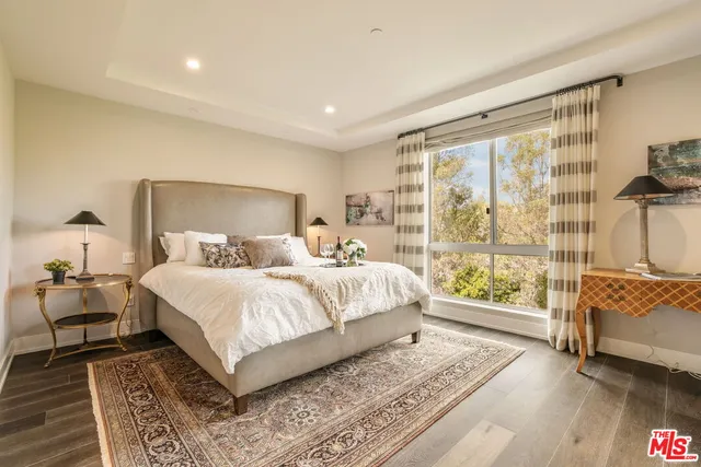 a bathroom with a tub sink shower and mirror